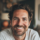 Portrait d'un homme souriant à l'intérieur.